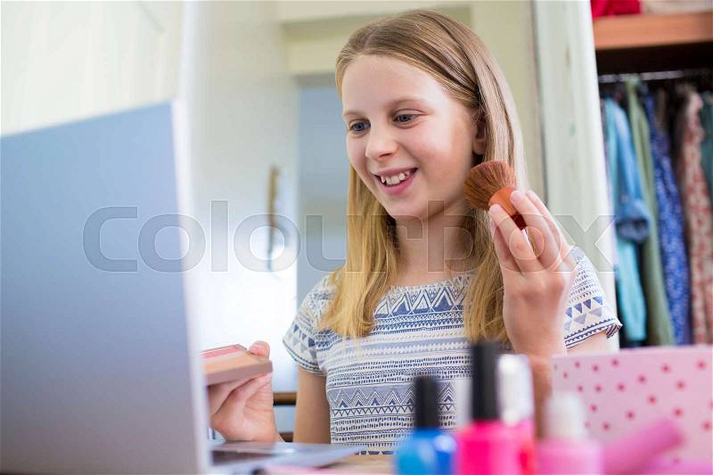 Young Girl Watching On Line Make Up Tutorial, stock photo