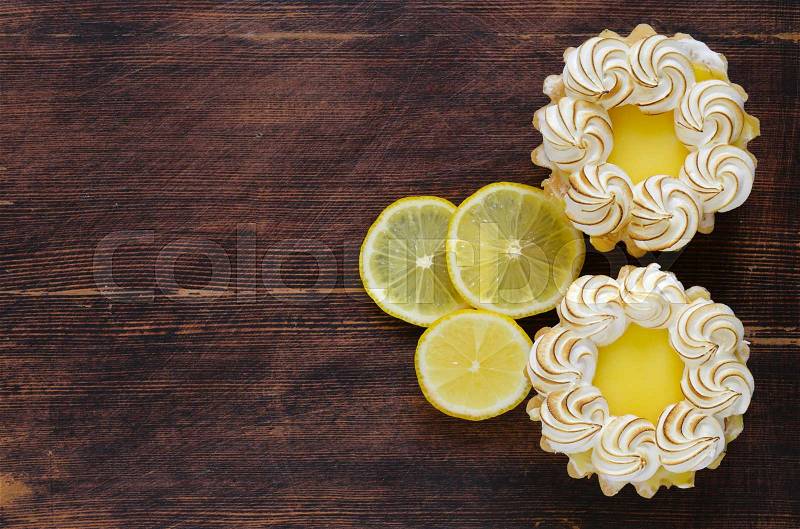 Tartlet with lemon cream and meringue on a table, stock photo