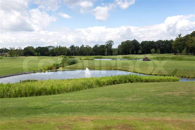 Beautiful pond on golf course at bright sunny day, stock photo