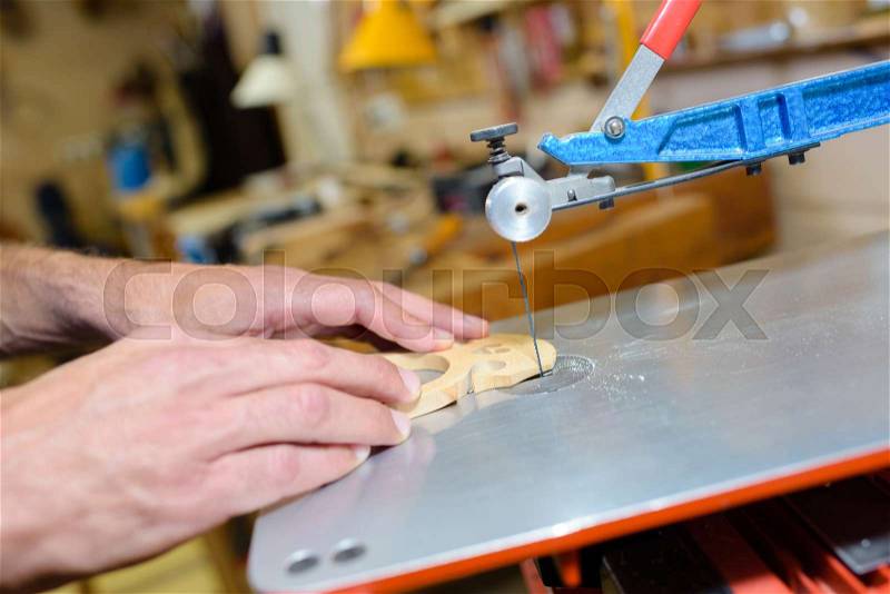 Craftsman cutting wood with fixed blade, stock photo