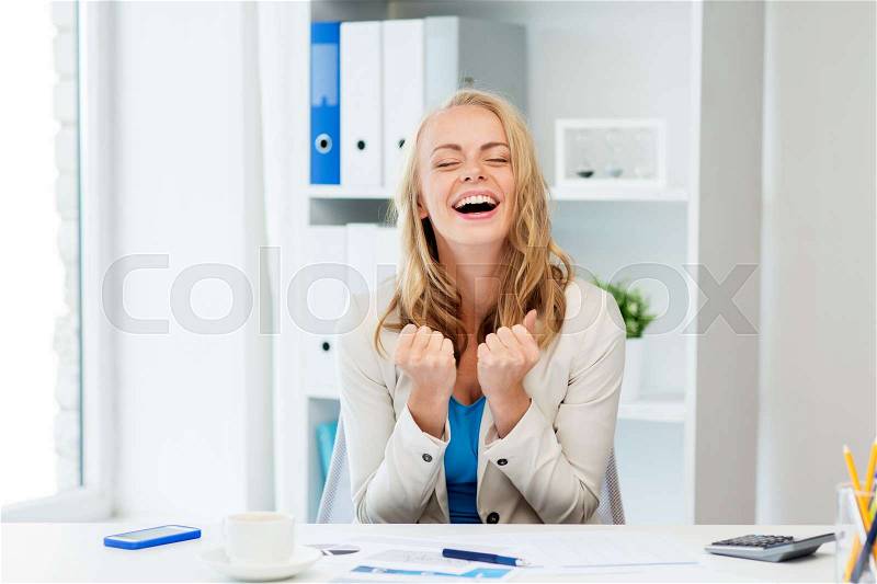 Business, people and success concept - happy businesswoman celebrating triumph at office, stock photo