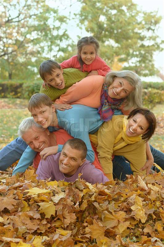 Happy smiling family relaxing in autumn forest, stock photo