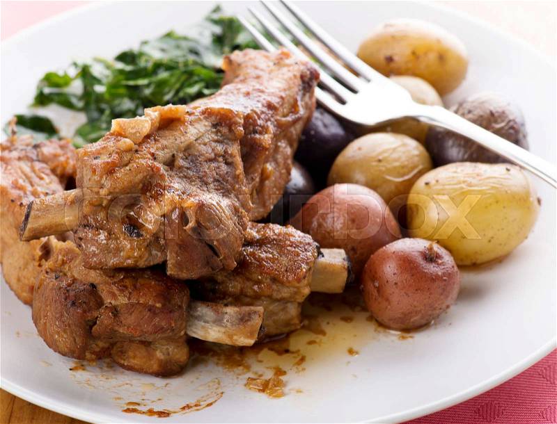 Pork Ribs with Fingerling Potatoes and Collard Greens, stock photo