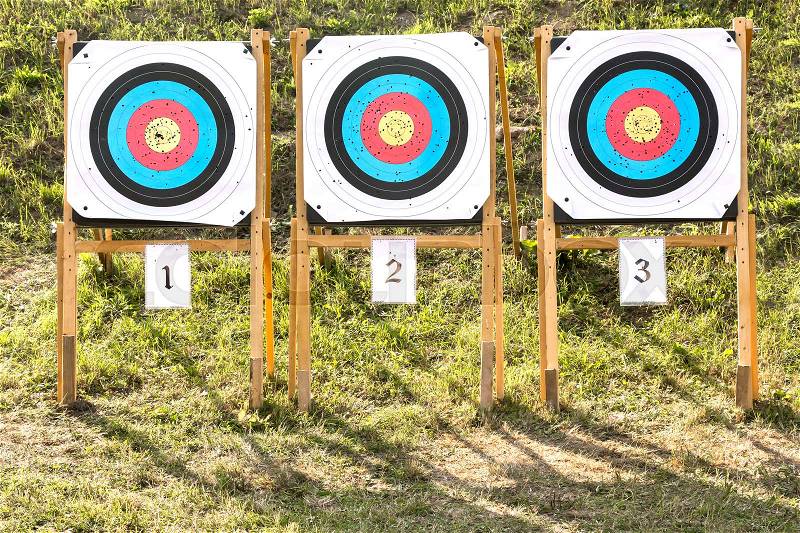 Three of paper archery targets in wooden stands , stock photo