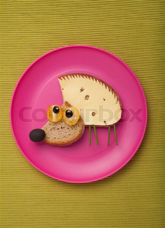 Hedgehog made of bread and cheese on plate, stock photo