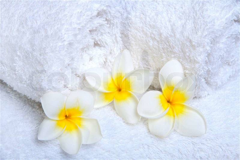 White towels with white flowers for wellness, stock photo