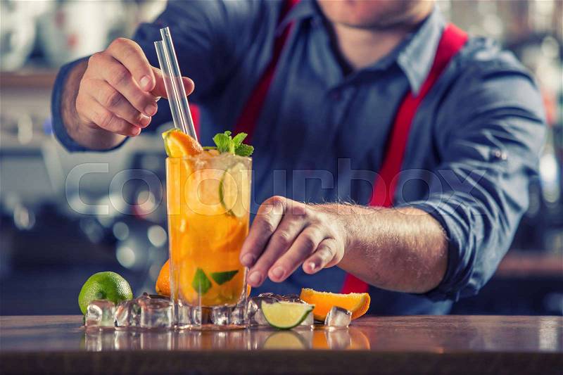 Mixed drink. Mixed alcoholic - non alcoholic cocktail. Barman Serving Drinks In Nightclub.Young barkeeper preparing drink, stock photo