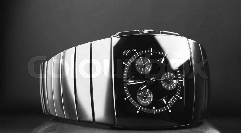 Mens chronograph watch made of high-tech ceramics with sapphire glass over black background. Closeup photo, selective focus, stock photo