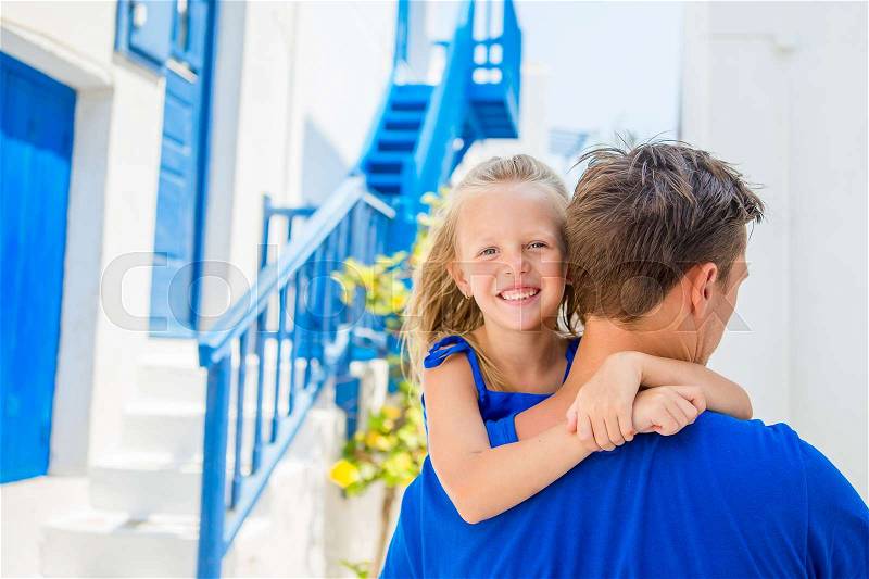 Family in Europe. Happy father and little adorable girl in Mykonos during summer greek vacation, stock photo