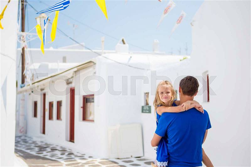 Family in Europe. Happy father and little adorable girl in Mykonos during summer greek vacation, stock photo