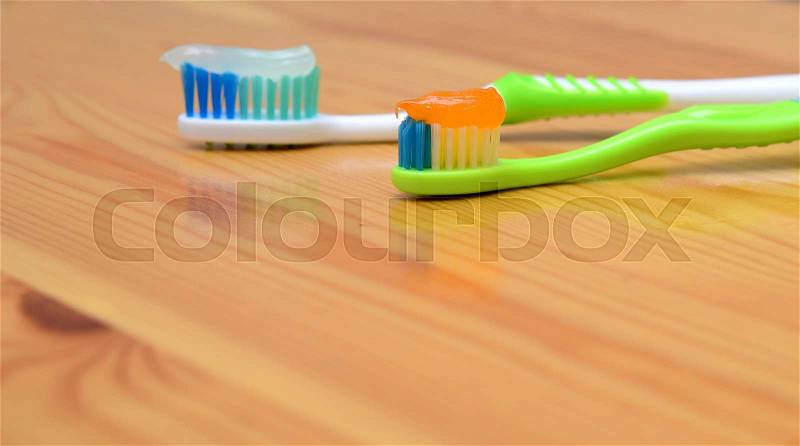 Toothbrush with toothpaste on a wooden background, stock photo