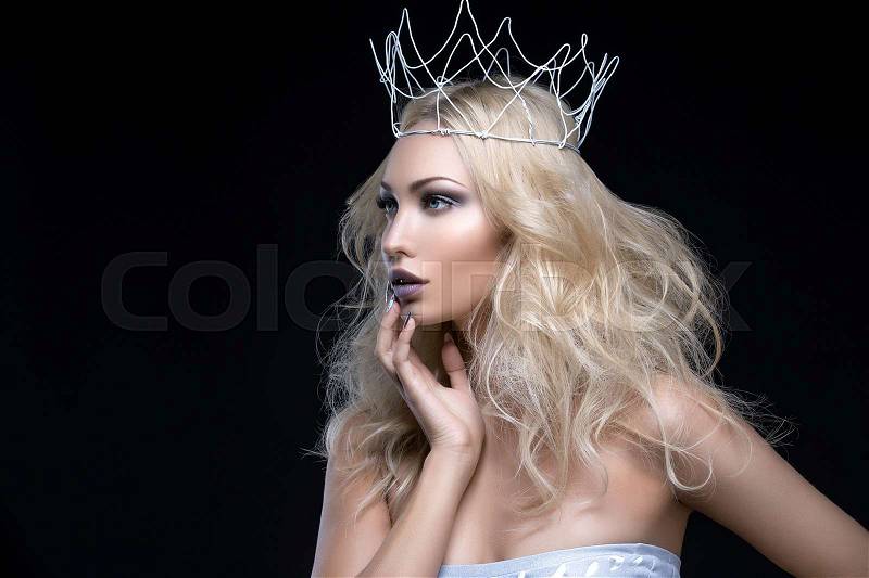 Beautiful young woman with crown. Cold tones. Copy space, stock photo