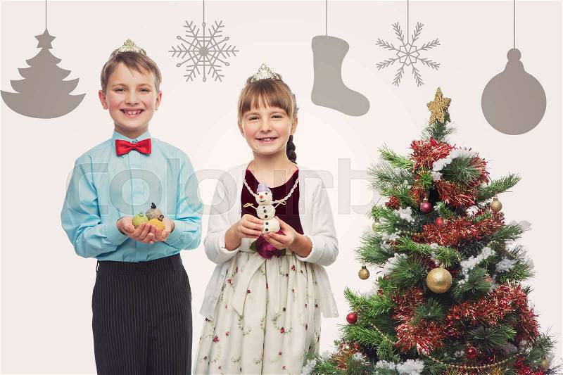 Children holding christmas cake pop dessert in shape of new year tree balls and snowman. Isolated over white background. Christmas tree. Copy space, stock photo