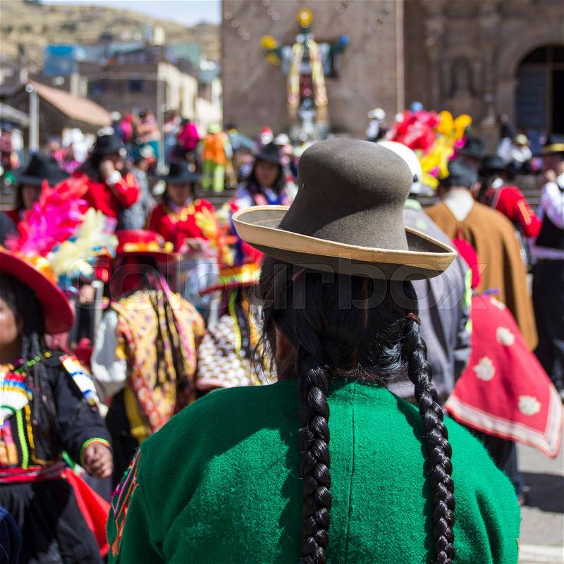 Puno, Peru - August 20, 2016: Native people from peruvian city dressed in colorful clothing perform traditional dance in a religious celebration. Peru, South America, stock photo