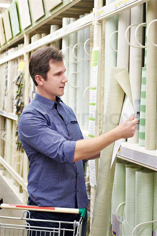 Man shopping wallpapers in DIY shop for construction, stock photo