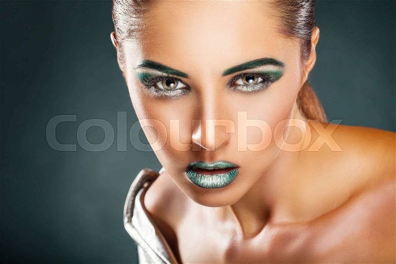 Beautiful young woman with fashion green makeup, stock photo