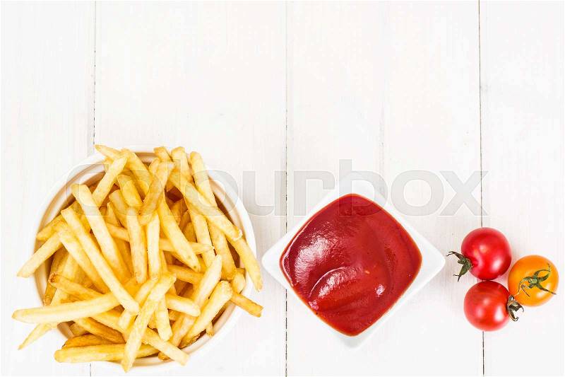 French Fries Potato with Ketchup on Rustic Wooden Background, stock photo