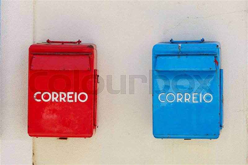 Reb and blue post boxes on the wall in Lisbon, Portugal, stock photo