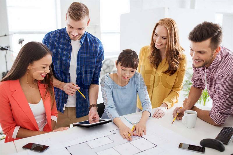 Business, startup, education and people concept - creative architect team or students with blueprint working at office, stock photo