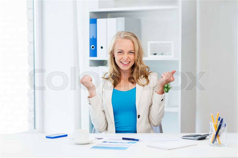 Business, people and success concept - happy businesswoman celebrating triumph at office, stock photo