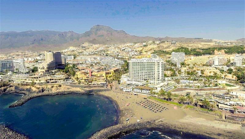 TENERIFE, SPAIN - SEPTEMBER 7, 2016: Panoramic aerial view of Playa de las Americas buildings. Tenerife attracts 5 million people annually, stock photo