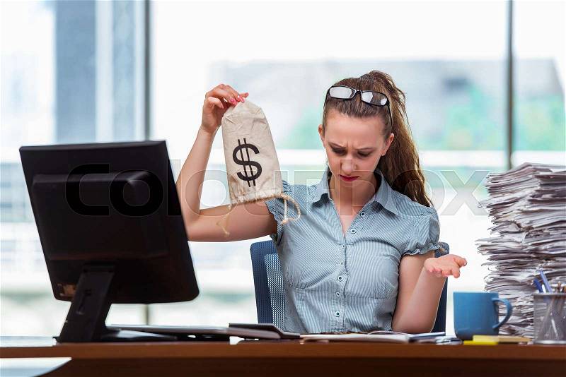 Businesswoman with money sacks in the office, stock photo