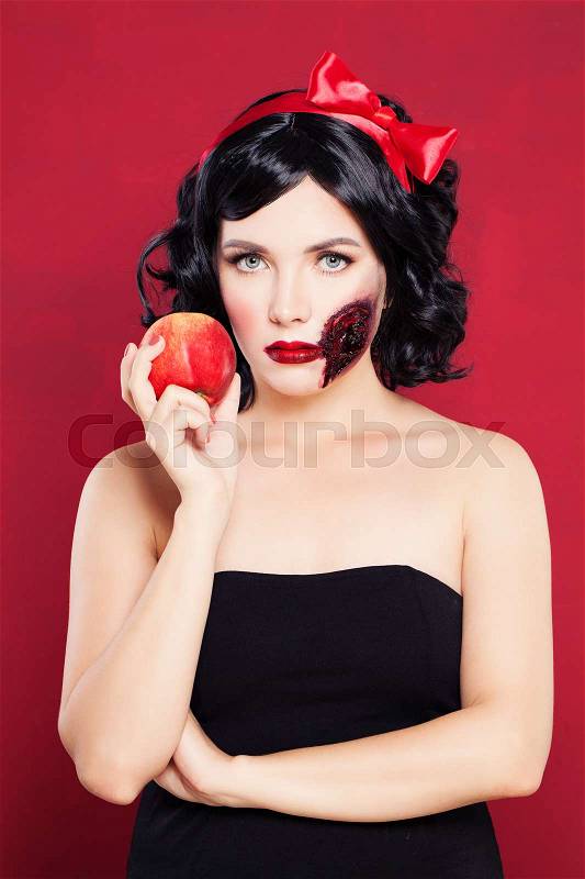 Halloween Concept. Woman with Wound and Poison Apple, stock photo
