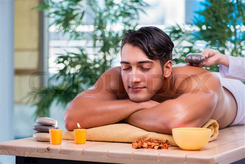 Handsome man during spa session, stock photo