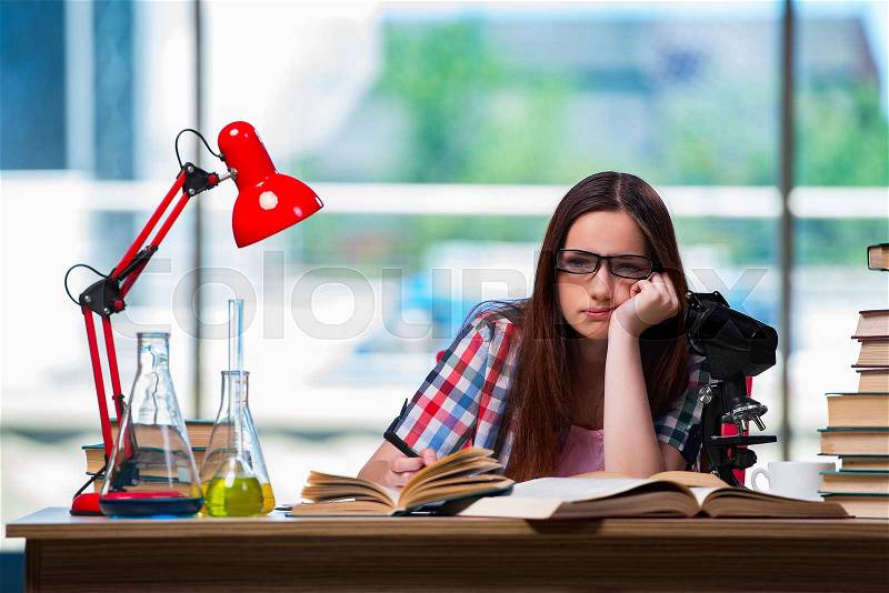 Sad student preparing for chemistry exams, stock photo