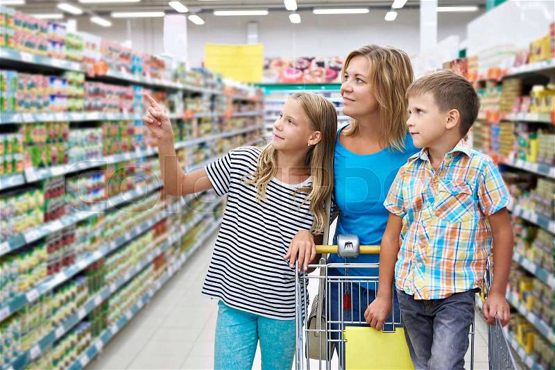 Mother and children are choosing products in shop, stock photo
