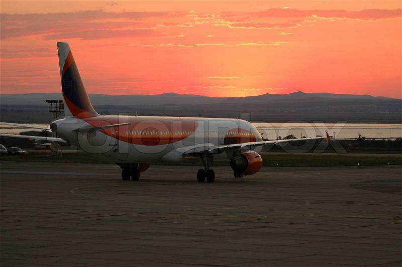 Airport, plane and sunset, stock photo