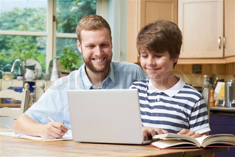 Male Home Tutor Helping Boy With Studies, stock photo