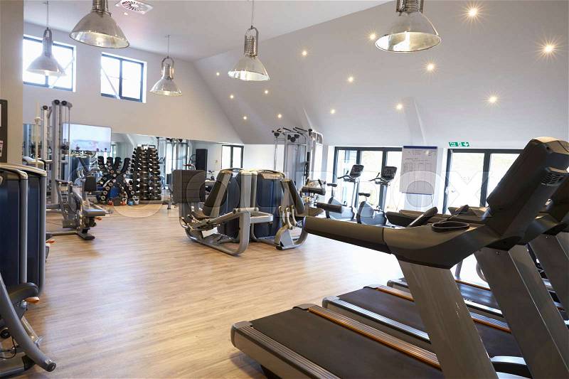 Empty gym with modern fitness equipment, stock photo