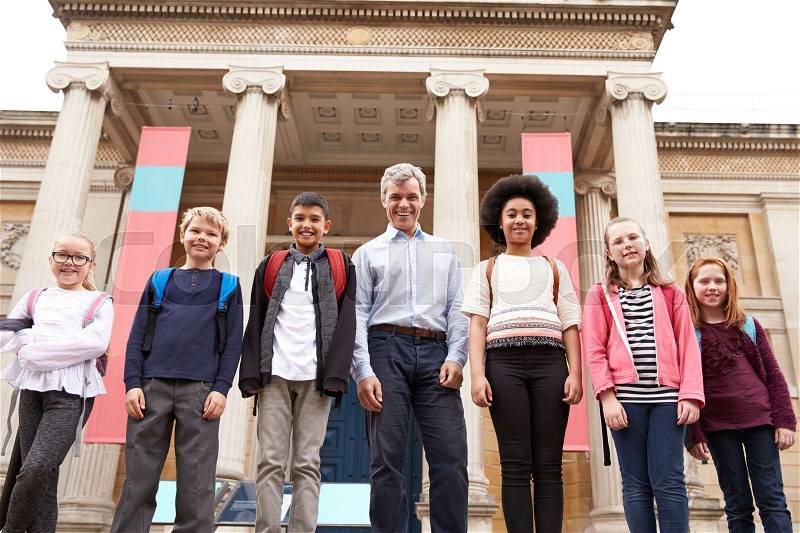 Portrait Of Teacher With Class Standing Outside Museum, stock photo