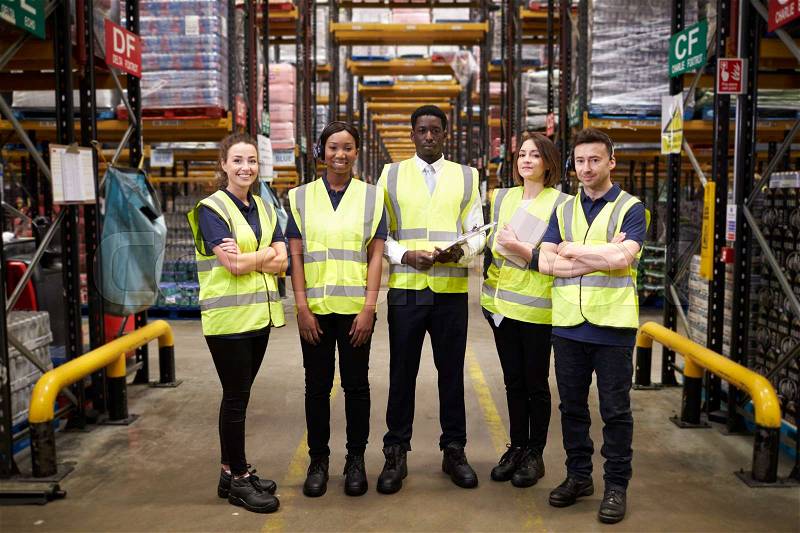 Group portrait of warehouse staff standing in the workplace, stock photo