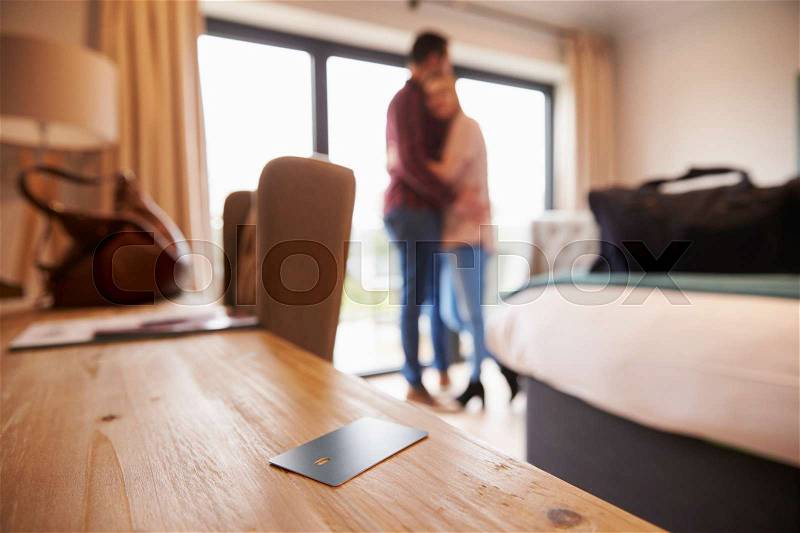 Hotel Room Key With Romantic Couple In Background, stock photo