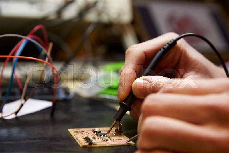 Close Up Of Electrical Engineer Soldering Circuit Board, stock photo