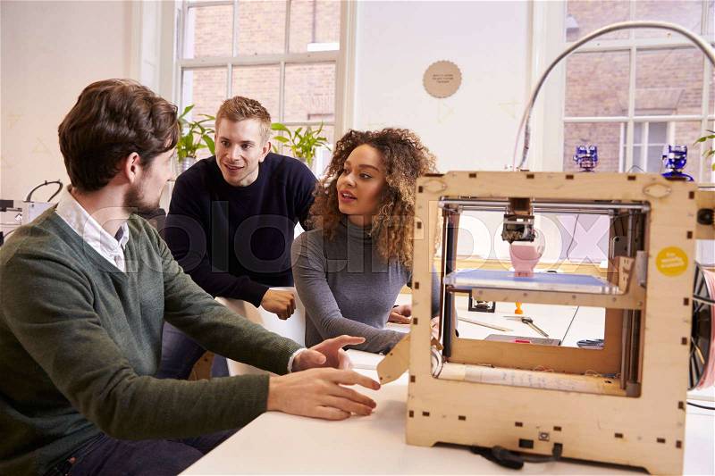 Team Of Designers Working With 3D Printer In Design Studio, stock photo
