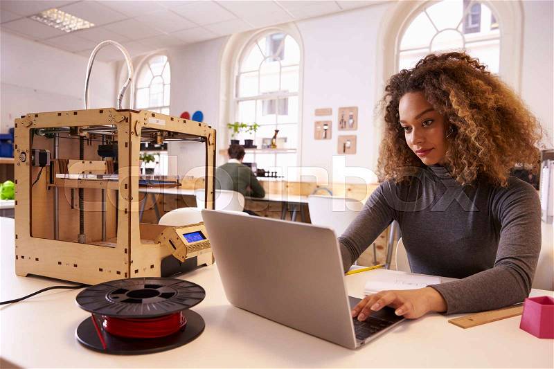 Female Designer Working With 3D Printer In Design Studio, stock photo