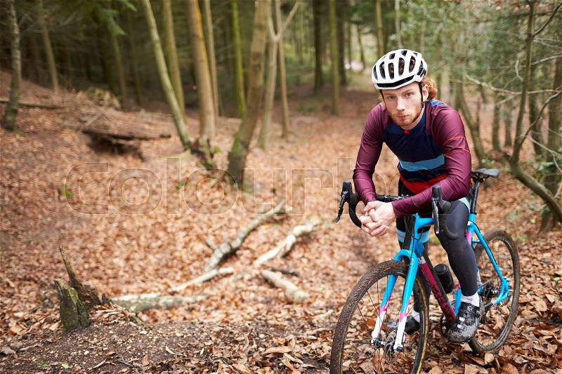 Portrait of man cross-country cycling in a forest, close up, stock photo