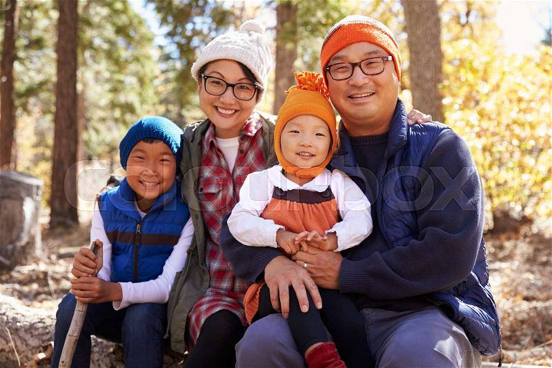 Portrait of Asian parents and two kids in a forest, stock photo