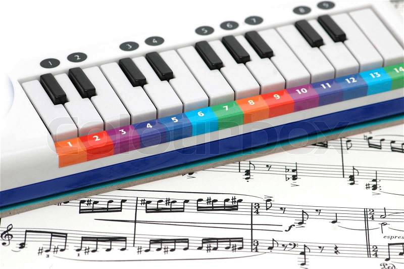 Notes and piano with numbered colourful keys, stock photo