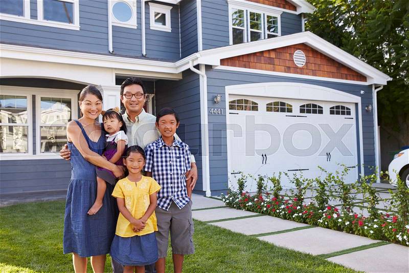 Portrait Of Family Standing Outside House, stock photo