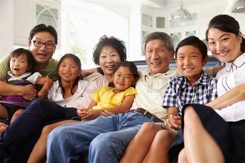 Portrait Of Extended Family Group Sitting At Home On Sofa, stock photo