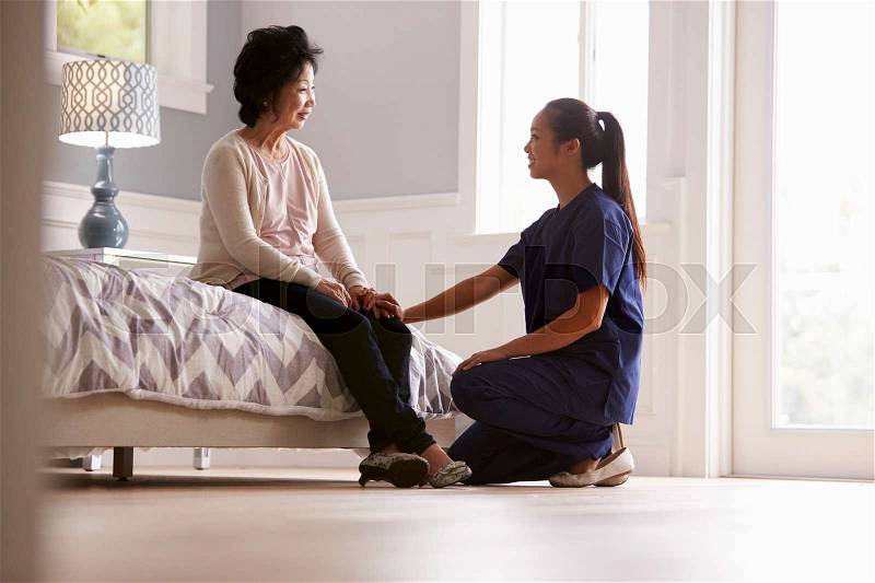 Nurse Making Home Visit To Senior Woman, stock photo