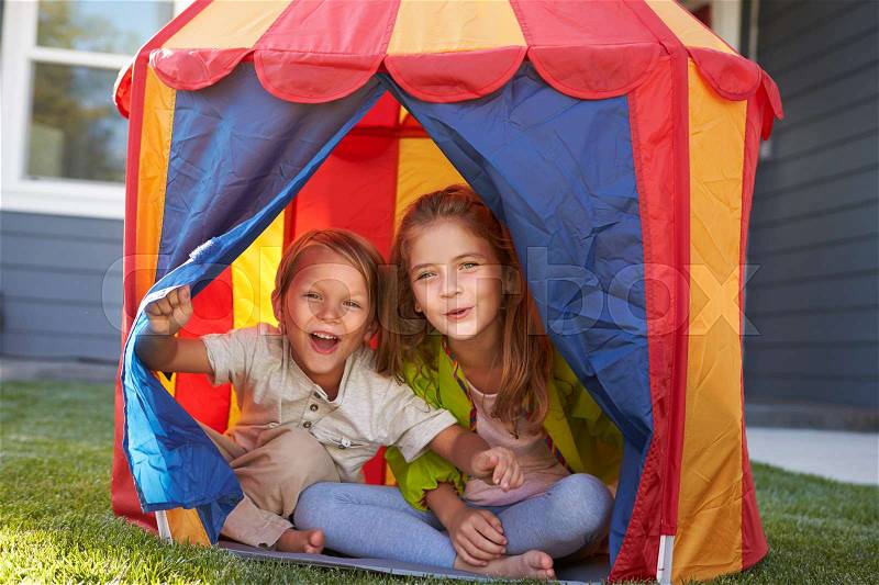 Two Children Playing Inside Tent In Garden Together, stock photo