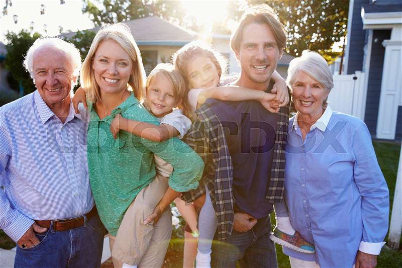 Portrait Of Family With Grandparents Standing Outside House, stock photo