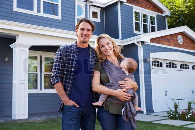 Portrait Of Family Standing Outside House, stock photo