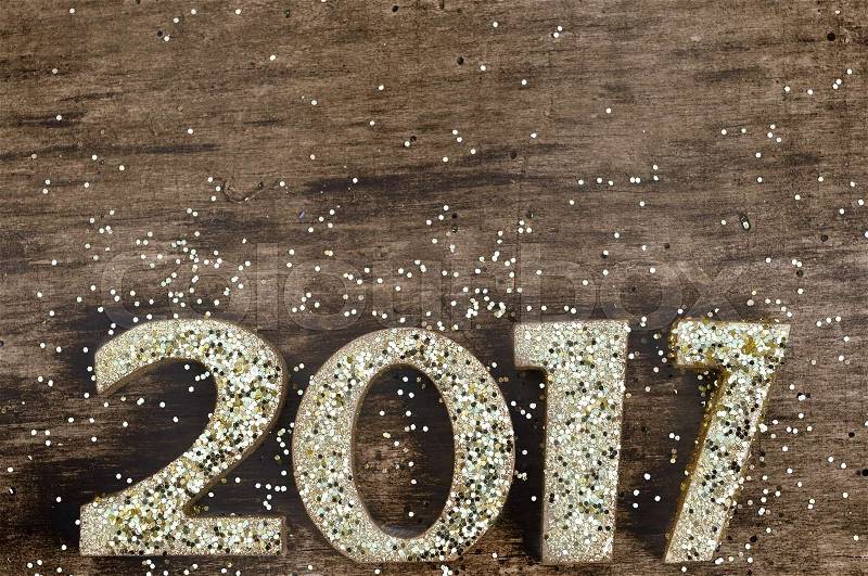 2017 on wooden panel with golden figures on glitters, stock photo