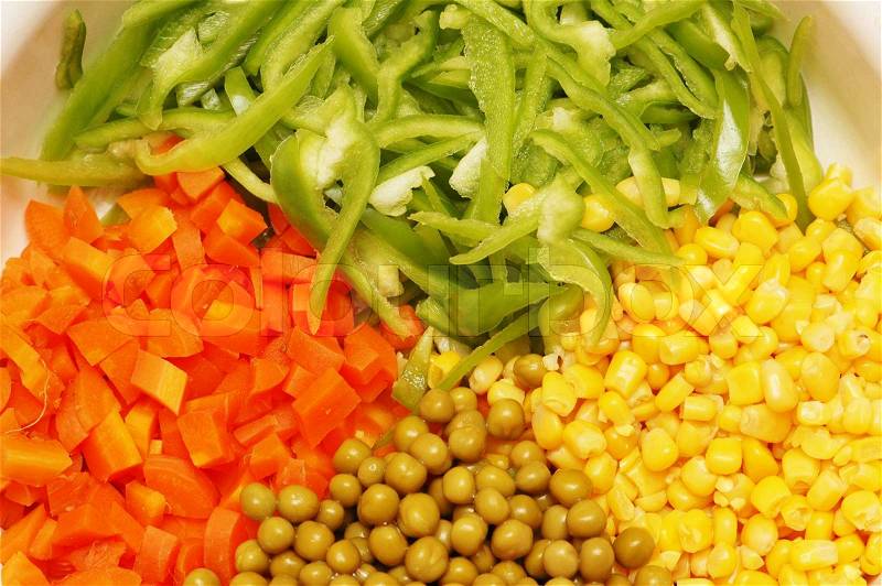 Close up of salad with corn, carrots, peppers and peas, stock photo